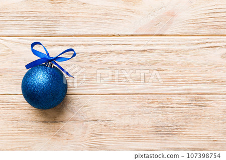 Christmas ball on colored background. decoration bauble with ribbon bow with copy space 107398754