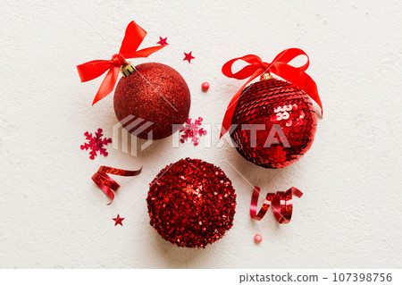 Christmas ball on colored background. decoration bauble with ribbon bow with copy space 107398756