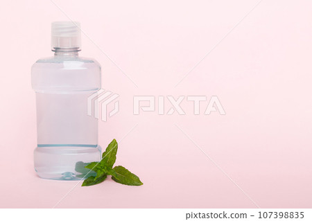 Mouthwash and fresh mint on colored background, top view with copy space for text 107398835