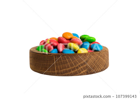 Multicolor small mixed colored chocolate coated candies in bowl, isolated on white Multicolor small mixed colored chocolate coated candies in bowl, isolated on white 107399143