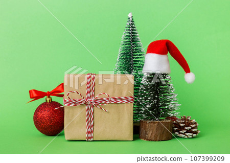 Christmas composition. Gifts, small tree, branches and craft DIY decorations on white background. New year concept. Christmas home decoration Flat lay, top view, copy space 107399209
