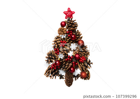 Isolated Christmas tree made from natural cones on colored background, view from above. New Year minimal concept with copy space 107399296