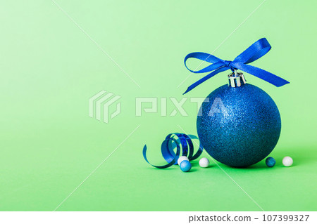Christmas ball on colored background. decoration bauble with ribbon bow with copy space 107399327