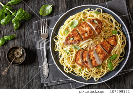 crusted chicken over lemon butter pasta, top view 107399551