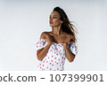 Gorgeous young adult woman posing in studio on white background 107399901
