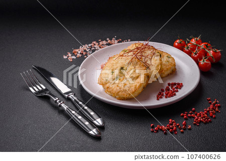 Delicious fried minced fish cutlets or meatballs with salt, spices and herbs 107400626