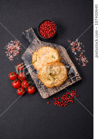 Delicious fried minced fish cutlets or meatballs with salt, spices and herbs 107400640