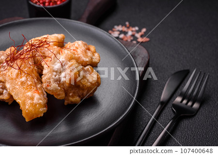Delicious juicy grilled chicken pieces in sweet and sour sauce with salt and spices 107400648