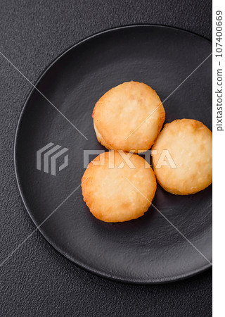 Delicious fresh sweet cheese pancakes with raisins and cinnamon Delicious fresh sweet cheese pancakes with raisins and cinnamon 107400669