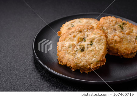 Delicious fried minced fish cutlets or meatballs with salt, spices and herbs 107400719