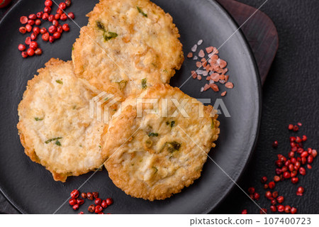 Delicious fried minced fish cutlets or meatballs with salt, spices and herbs 107400723