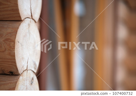 Natural background pattern of log wall. Construction of houses made of wood, rounded timber 107400732