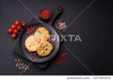 Delicious fried minced fish cutlets or meatballs with salt, spices and herbs 107400858