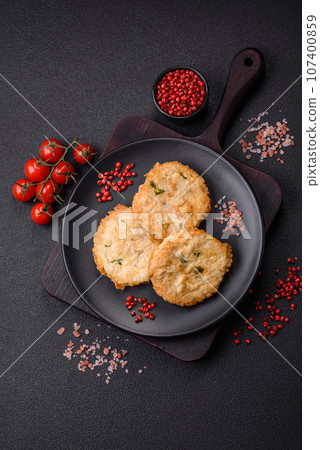 Delicious fried minced fish cutlets or meatballs with salt, spices and herbs 107400859