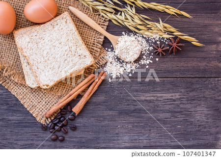 Ears of wheat on a dark wooden background 107401347