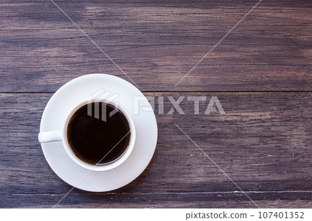 Cup of coffee on wooden table Cup of coffee on wooden table 107401352