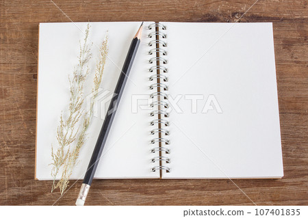 Pencil and notebook on wooden table background 107401835