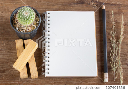 Pencil and notebook on wooden table background Pencil and notebook on wooden table background 107401836