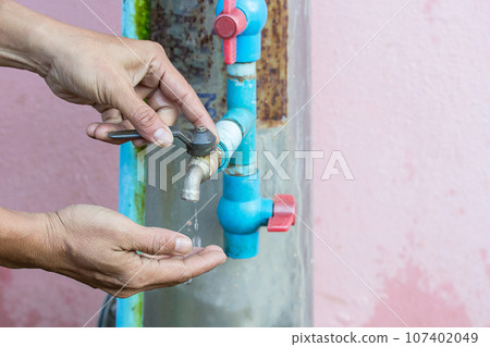 Closed up metal water faucet which is closed by right hand. 107402049