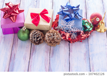 Christmas and happy new year gift box and red ribbon with tag on wood background. 107402126