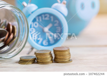 Coin stacks on wood table background. Coin stacks on wood table background. 107402244