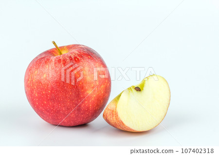 Sliced red apple on white background. Sliced red apple on white background. 107402318