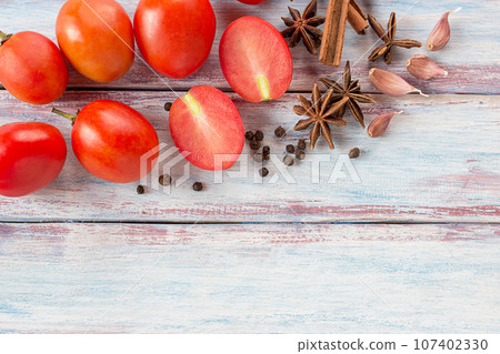 red cherry plum tomatoes on wood table background red cherry plum tomatoes on wood table background 107402330