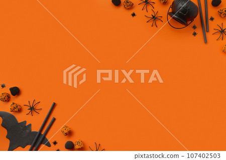 Halloween decor on an orange black background. Flat lay top view 107402503