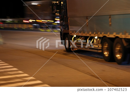 Large truck running late at night Large truck running late at night 107402523