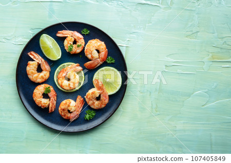 Shrimps, shot from above with a place for text on a teal blue table Shrimps, shot from above with a place for text on a teal blue table 107405849