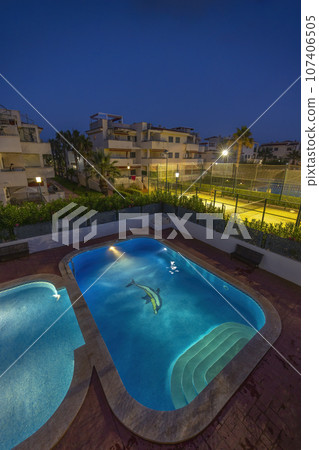 illuminated swimming pool at night 107406505