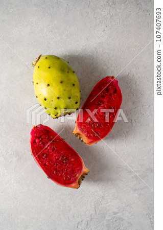 Prickly pears, exotic cactus fruits cut in halves, top view. Prickly pears, exotic cactus fruits cut in halves, top view. 107407693