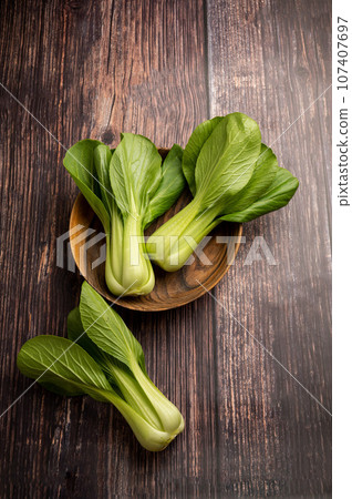 Celery cabbage or peach choi, asian baby salad leaves on wooden background Celery cabbage or peach choi, asian baby salad leaves on wooden background 107407697