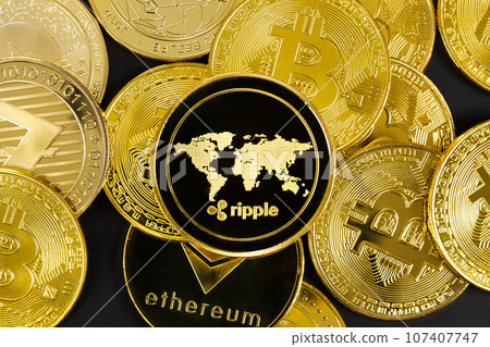 Close-up of Ripple coin on top of various golden cryptocurrencies Close-up of Ripple coin on top of various golden cryptocurrencies 107407747