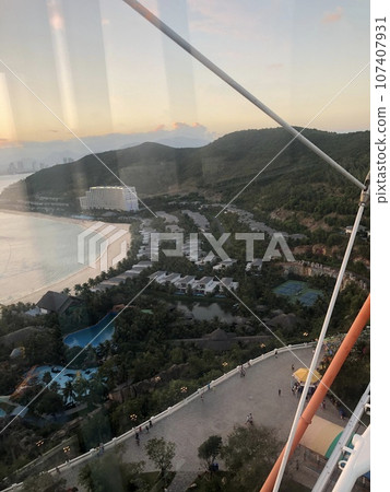 beautiful sunset on the ocean. Vietnam. The sun sets behind the horizon, through the coco, reflected in the water beautiful sunset on the ocean. Vietnam. The sun sets behind the horizon, through the coco, reflected in the water 107407931