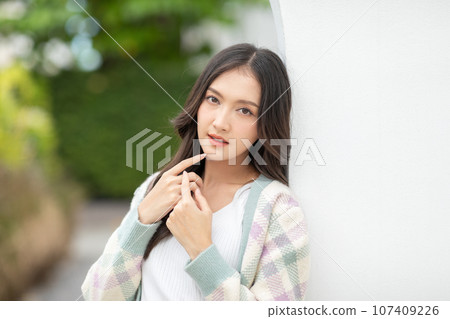 Beautiful asian young woman smile and cheerful. Confident cute female looking at camera relax and happiness with wellness life. good moment and positive emotional. Happy woman enjoy her life concept 107409226