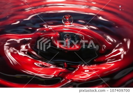 Formation of ripples and drops spreading on the water surface 107409700