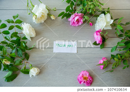 Floral background of pink and white roses on a light wooden Floral background of pink and white roses on a light wooden 107410634