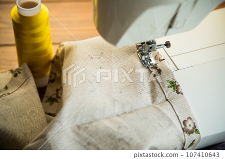 Sewing machine with fabric and threads for sewing, close-up. The working process Sewing machine with fabric and threads for sewing, close-up. The working process 107410643