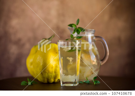 Prepared compote from ripe natural autumn quince, in a glass glass and decanter . 107410678