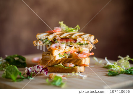 sandwich with lettuce and shrimp. 107410696