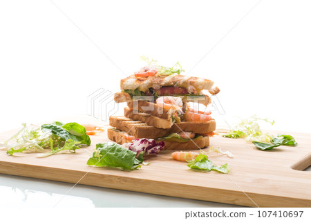 sandwich with lettuce and shrimp. 107410697