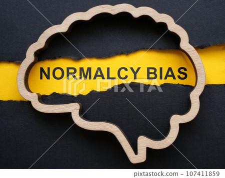 Brain outline, torn paper and sign normalcy bias. Brain outline, torn paper and sign normalcy bias. 107411859