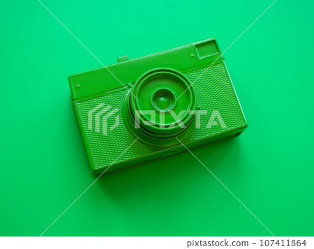 Top view of green film camera. Minimal trendy style. 107411864