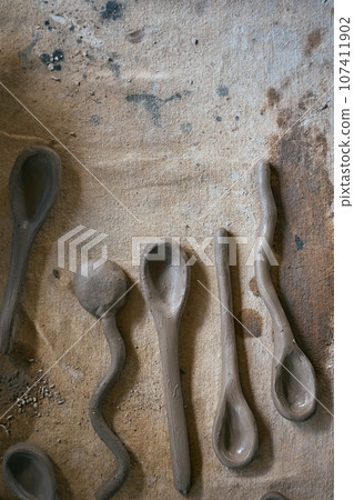 Close up clay spoon on rustic background Close up clay spoon on rustic background 107411902