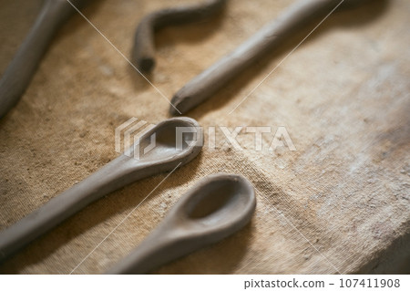 Close up clay spoon on  rustic background 107411908