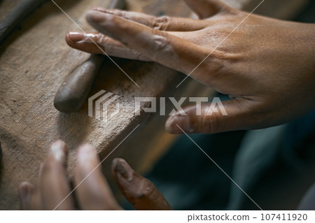 Close up of hands shaping ceramic Close up of hands shaping ceramic 107411920