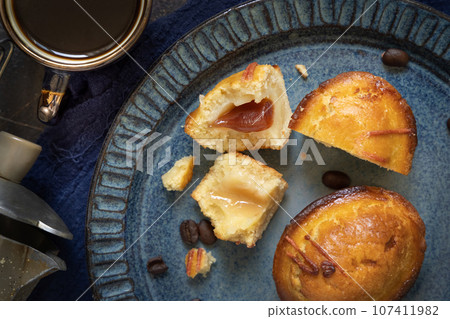 Pasticciotto leccese pastry filled with egg custard cream and sour cherry jam on a plate top view 107411982
