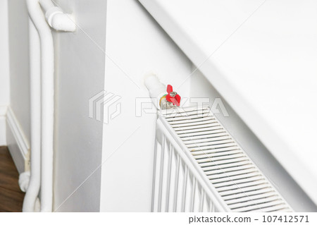 temperature regulator on the radiator, thermostatic radiator. concept of heating and energy crisis. temperature regulator on the radiator, thermostatic radiator. concept of heating and energy crisis. 107412571