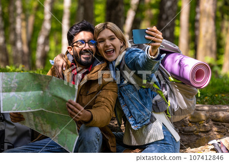 Happy travelers making selfie and looking enjoyed Happy travelers making selfie and looking enjoyed 107412846